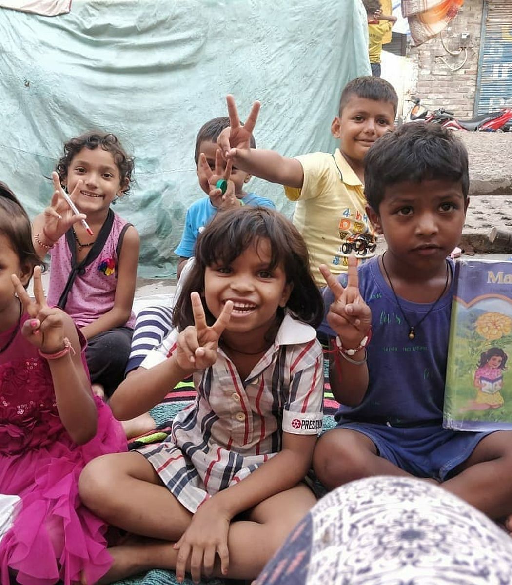 Smiling students showing their books