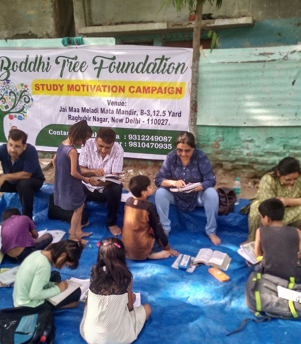 Children studying with volunteers at our Study Motivation Campaign